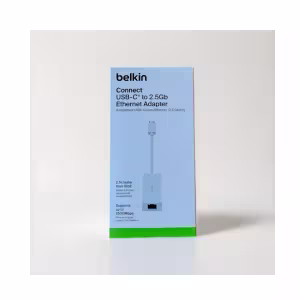 A high-resolution photo of the Belkin 2.5GB Ethernet Adapter in black, featuring a USB-C connector and a high-speed RJ45 port.